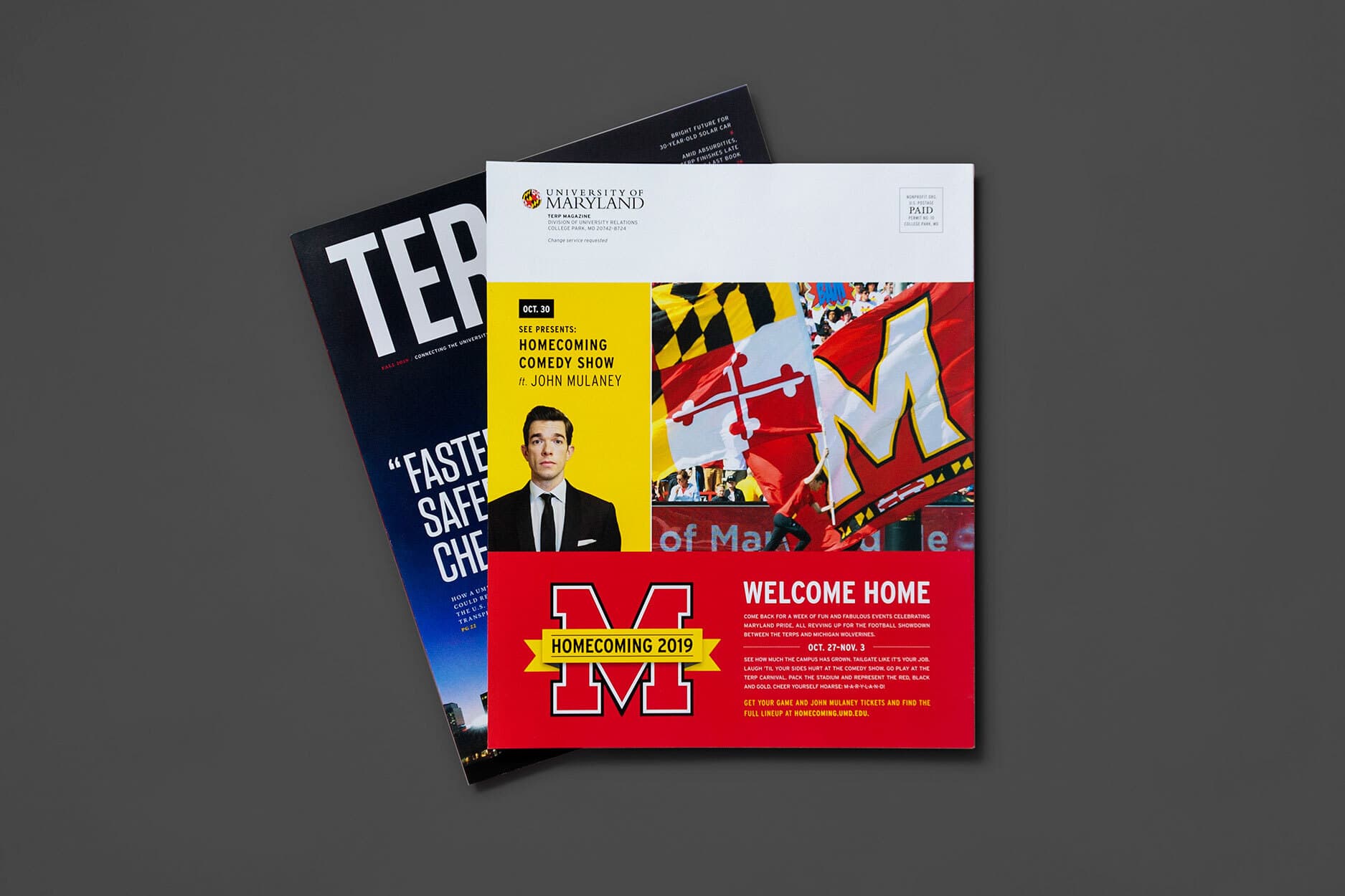 Examples of homecoming print materials including a short zine in front of the latest Terp Magazine issue.