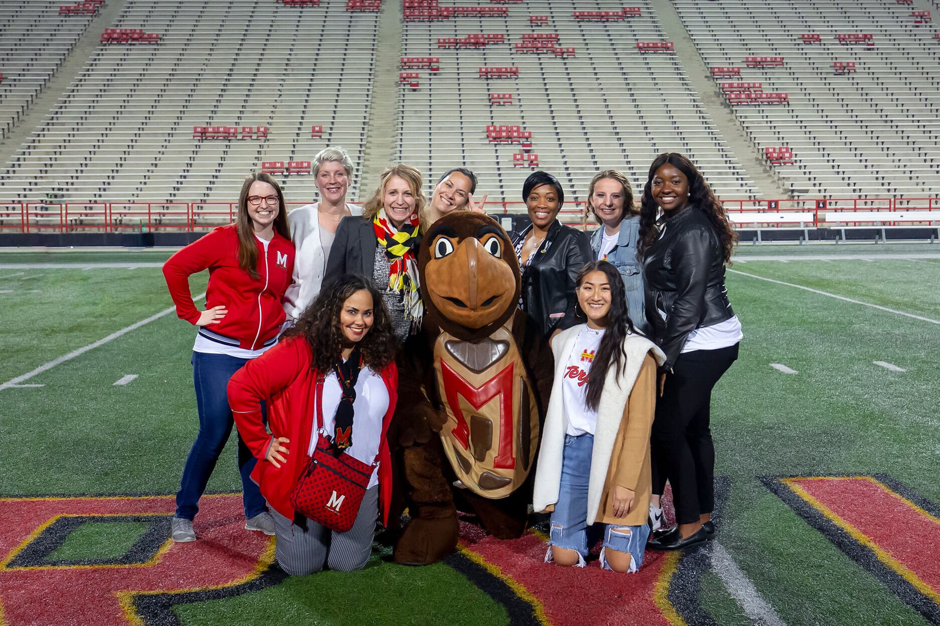 Members of the UMD Office of Marketing and Communications take a group photo with Testudo the mascot in the middle